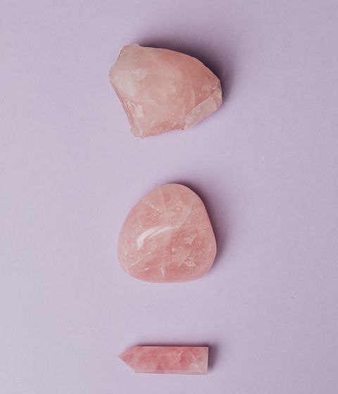 Pink rose quartz stones arranged on a soft surface