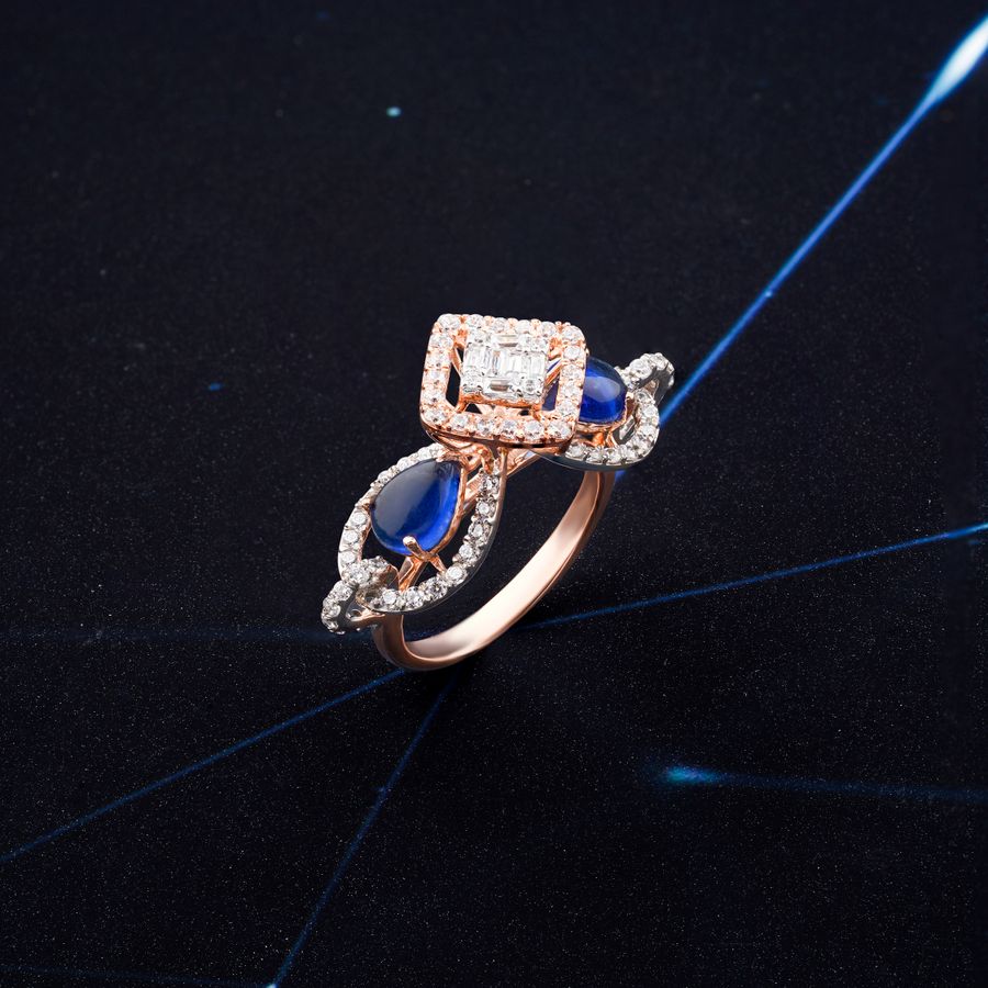 Side profile of a sapphire and diamond ring on a dark surface